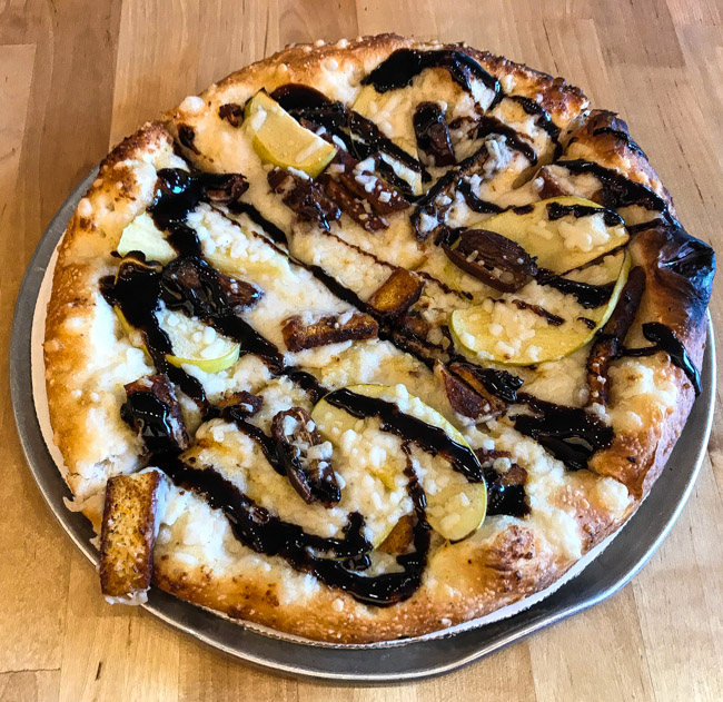 The Date Upton pizza from Pie Sci in Detroit, MI is a white pizza with mozzarella, dates, thin sliced apple, tempeh, and a balsamic drizzle. We got this pie as the vegan option. Find the full post at www.thebite2night.com