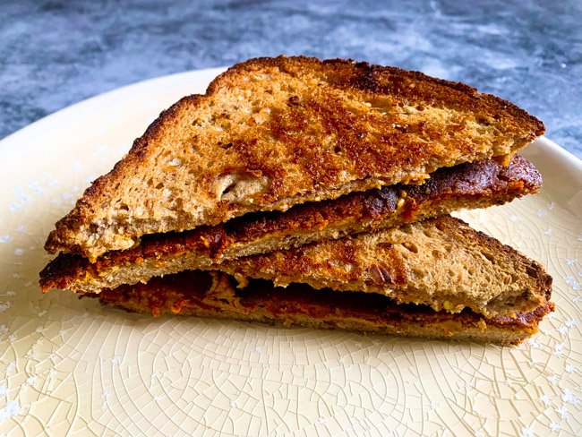 This Vegan Peanut Butter & Bacon Sandwich uses plant based hickory and sage bacon, creamy peanut butter, and a hearty multigrain bread. Find the full post at www.thebite2night.com